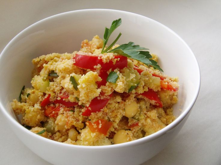 a white bowl filled with food on top of a table