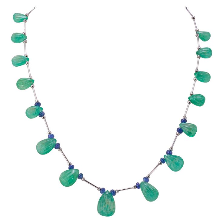 This special piece will never go out of style and will make you feel more gorgeous. From the boardroom to the ballroom, this necklace will make heads turn! This necklace is around 21 inches long. Stone Details: Emerald Carving Drop: 75.32 Carats Tanzanite Beads: 6.54 Carats 18K White Gold Zelda Au, Tanzanite Beads, Necklace Art Deco, Tanzanite Necklace, Elegant Jewellery, Necklace Art, Drop Beads, Knot Necklace, Drop Necklace