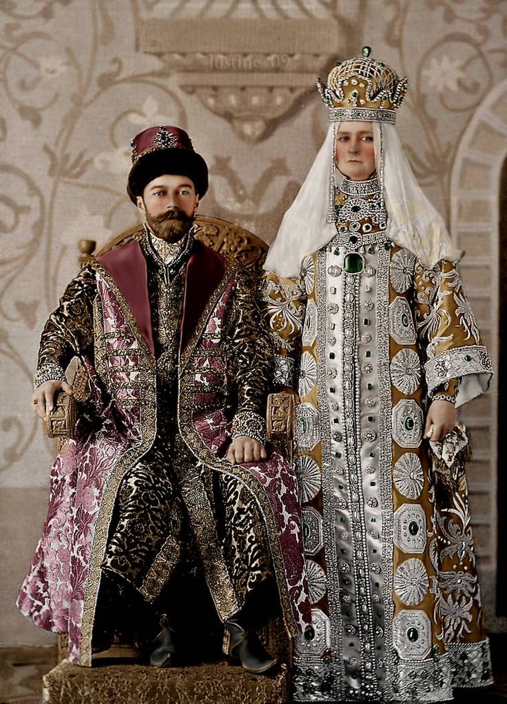 two figurines are dressed in fancy clothing