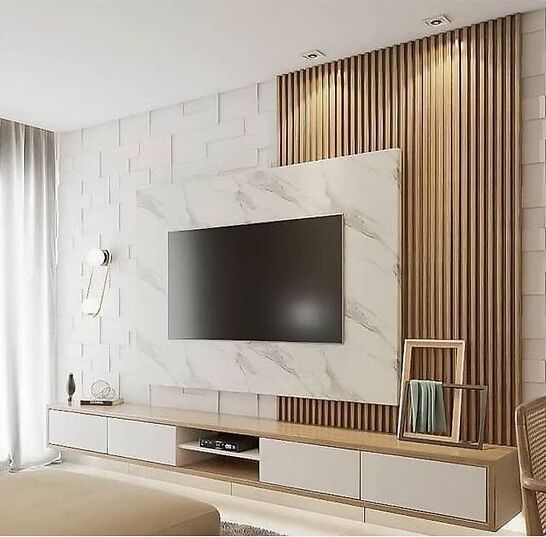 a large flat screen tv mounted to the side of a wall in a living room