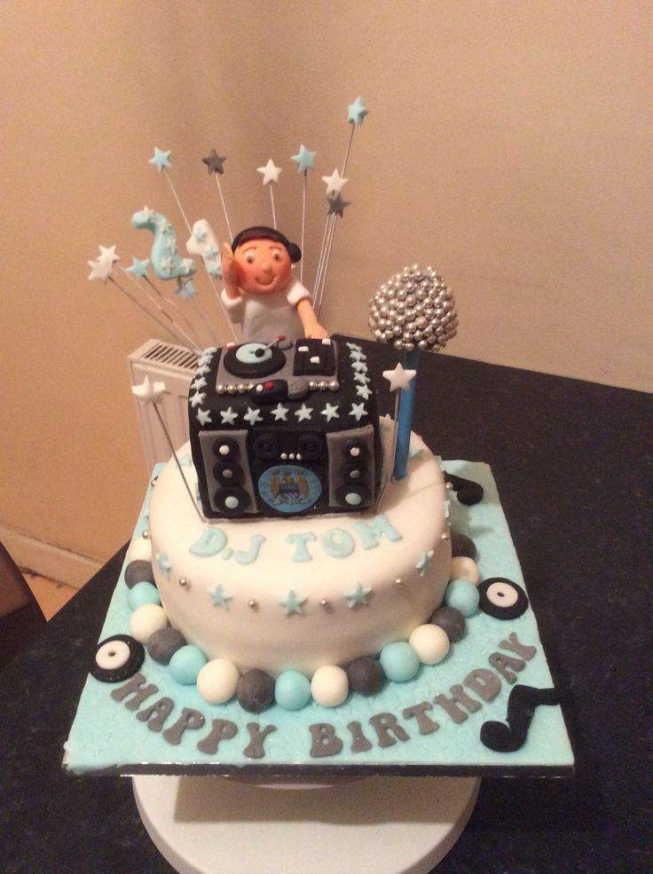 a birthday cake with a man sitting on top of it