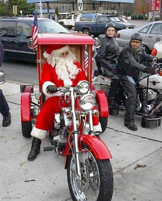 a man dressed as santa claus riding on a motorcycle with a side car attached to it