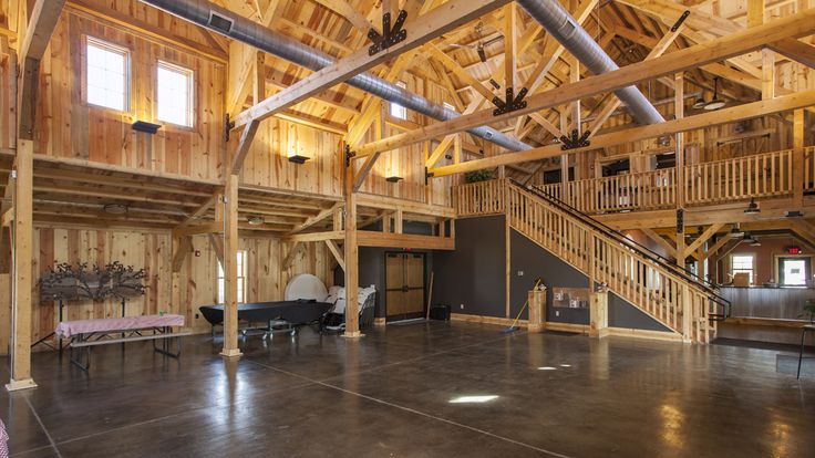 the inside of a large wooden building with stairs