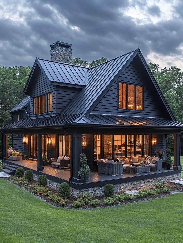 a large black house with lots of windows on it's roof and covered patio