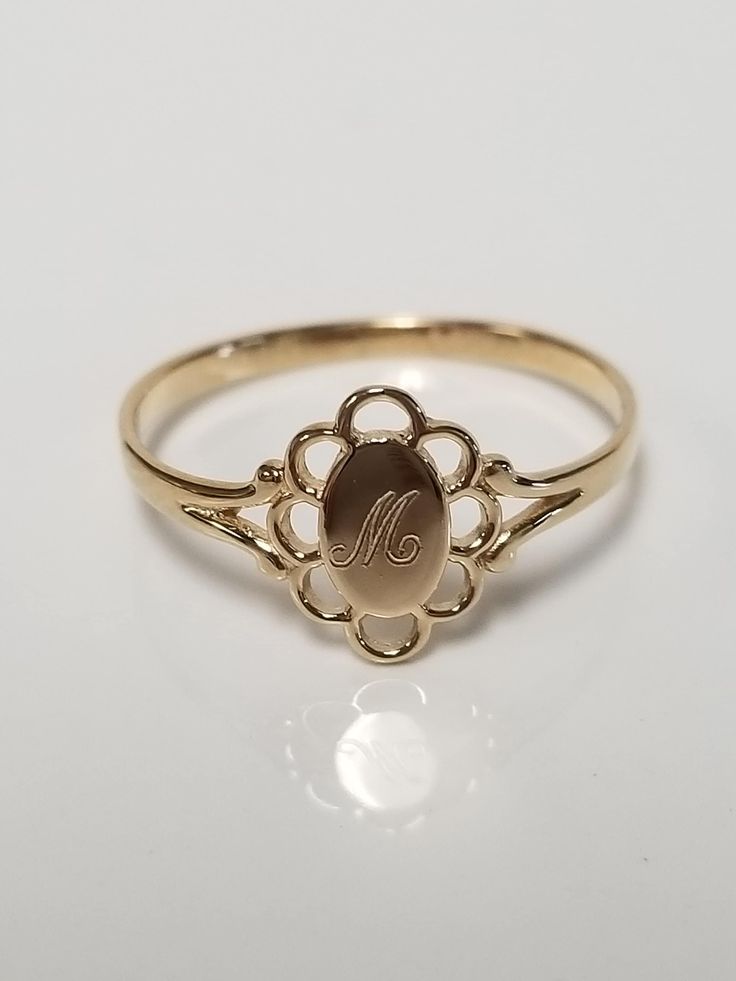 "Thanks for shopping our vintage estate store. We tend to sell well below wholesale and truly hope you enjoy all of our items. Many of the items are one of a kind, so please enjoy scrolling through the pictures and hopefully something will catch your eye. Brown spots are from camera or reflections. Estate 14k yellow gold monogram cursive capital M filigree ring. Custom made ring for our shop. Ring size: 4.5 Setting: 1/4\" to 3/8\" Band width: 1.4mm Weight: .73 gram Marked 14k and it's sweet. One Oval Gold Engraved Ring Collectible, Oval Gold Engraved Ring For Collectors, Classic 14k Gold Filigree Ring In Oval Shape, Vintage Hallmarked Engraved Ring For Formal Occasions, Classic Yellow Gold Engraved Ring With Maker's Mark, Antique Style Initial Ring For Anniversary, 14k Gold Signet Ring With Maker's Mark As Gift, Gold Engraved Ring With Hallmarks For Formal Occasions, Formal 14k Gold Engraved Ring With Maker's Mark