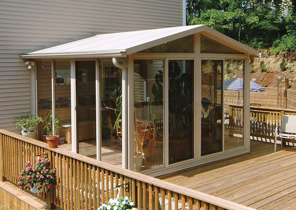 a wooden deck with a small white house on it