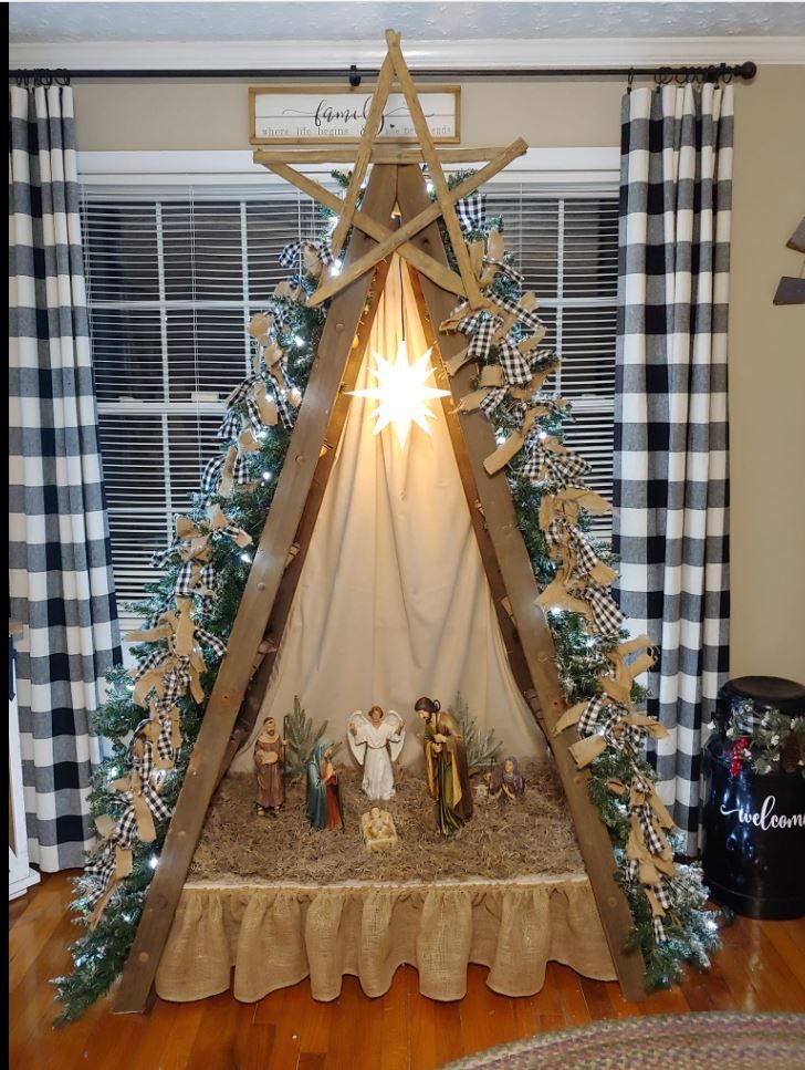 a nativity scene is displayed in front of a window