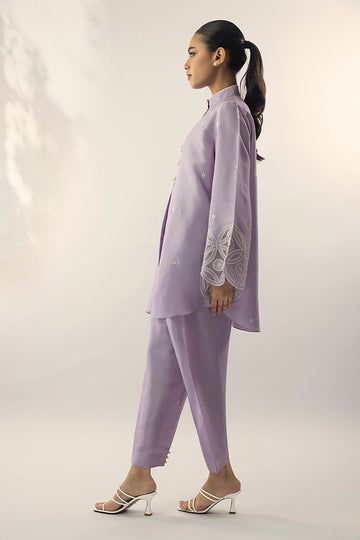 A refreshing lilac shade on a raw silk kurta, is adorned with embroidery on the sleeves and pearl buttons. Pair it with a co-ord trouser. Classy, elegant and summer ready. Elegant Sets With Set-in Sleeves And Straight Pants, Bollywood Style Straight Kurta Set With Embroidered Sleeves, Eid Chikankari Embroidered Straight Pant Set, Eid Chikankari Embroidery Straight Pant Set, Designer Spring Kurta With Set-in Sleeves, Designer Wear Spring Kurta With Set-in Sleeves, Elegant Pant Set With Dabka And Straight Kurta, Elegant Cotton Bandhgala Straight Kurta, Elegant Dabka Straight Kurta Pant Set