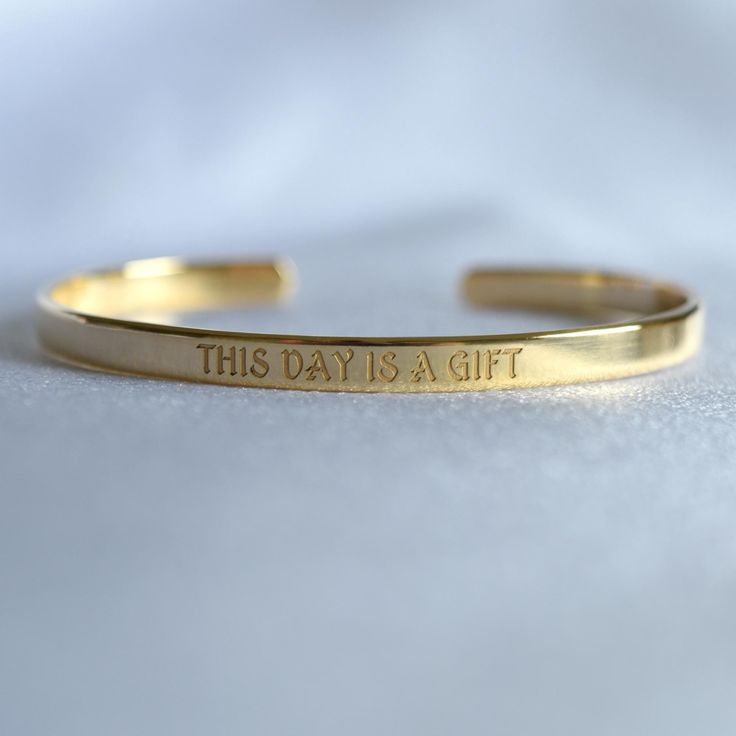 You can engrave this quote or any other text on our gold-plated timeless bracelet. - Narrow bracelet engraved with your chosen message. - The  thickness of gold plating is around 0.5 microns - Text, coordinates, numbers or handwriting outside and inside the cuff  - Up to 90 characters  on each side - Approximately 5mm wide, 16cm long This personalised gold plated bangle will make the perfect gift for mum, sister, grandma, bridesmaid or any other loved one in your life. SIZES: This is the length of the metal, not including the opening between the ends. The bracelets are adjustable. 4" (baby/toddler size) 5" (child size) 6.3" (standard - fits MOST adults) 7" (popular for men) With an elegant radiance to captivate the eyes, this gold-plated cuff will make you stand out from the crowd! Colors Engraved Name Bracelet For Personalized Gift, Meaningful Engraved Name Bracelet, Engraved Name Bangle Bracelet As Gift, Meaningful Engraved Bracelet Jewelry, Inspirational Engraved Name Bracelet, Gold Engraved Name Bracelet With Meaningful Style, Meaningful Engraved Bracelets As Gifts, Minimalist Engraved Bracelets For Personalized Gifts, Minimalist Engraved Bracelets For Friendship