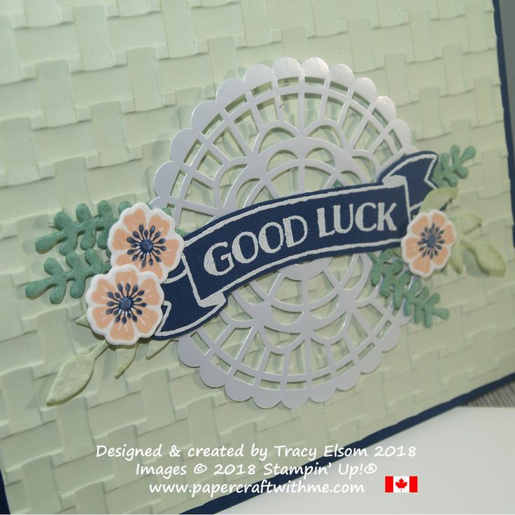 a close up of a greeting card with flowers and a good luck ribbon on it