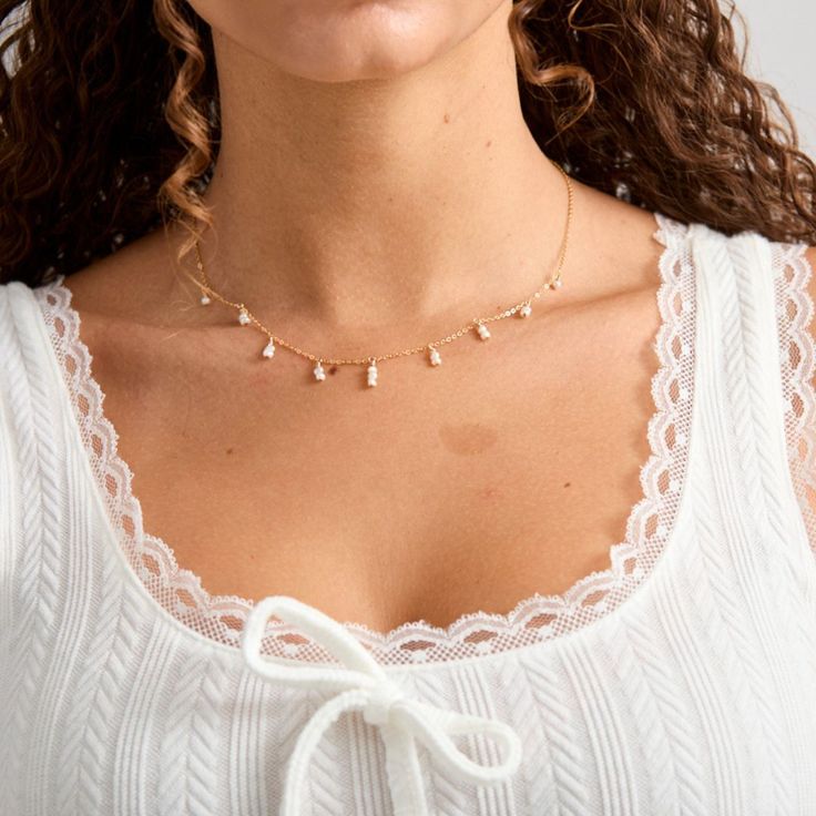 Tiny freshwater pearls adorn this dainty gold filled chain. They are tiered in a 3-2-1 count to create a layering effect. These pearls are tiny and off round. They are freshwater pearls so slight differences are to be expected. - Tiny 2-3mm roundish freshwater pearls- 14K Gold filled chain and clasp Dainty 14k Gold Filled Pearl Necklace For Everyday, Dainty White Layered Pearl Chain Necklace, Dainty Pearl Necklace For Layering With Pearl Chain, Dainty Pearl Necklace For Layering, Delicate 14k Gold Filled Pearl Drop Necklace, Dainty 14k Gold-filled Pearl Drop Necklace, Dainty 14k Gold Filled Pearl Drop Necklace, Dainty 14k Gold Filled Necklace With Pearl Chain, Dainty Layering Jewelry With Pearl Drop