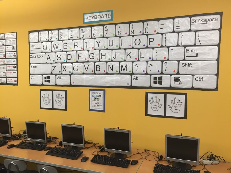 there are many computers on the desks in this room, all with keyboards and mouses