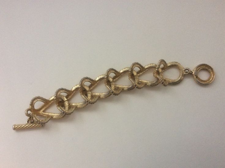 "Givenchy brushed gold, matte gold, satin gold twisted wire link bracelet Very good condition size - 7.5\" with clasp x 1\"" Formal Brass Bracelets With Lobster Clasp, Gold Metal Chain Bracelet For Party, Elegant Antique Gold Metal Bracelets, Gold Metal Chain Bracelet For Formal Occasions, Gold Metal Chain Bracelet For Wedding, Adjustable Bronze Bracelets For Formal Occasions, Formal Gold Metal Chain Bracelet, Elegant Antique Gold Metal Bracelet, Adjustable Gold-tone Gold Bracelet With Gold Clasp