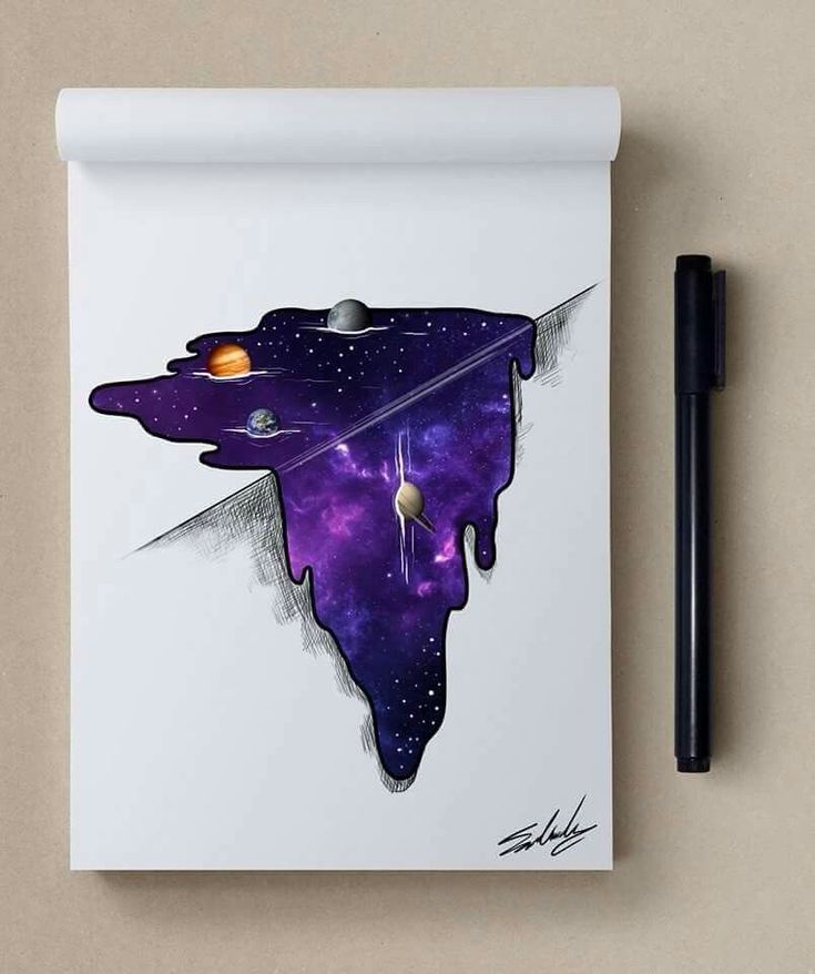 a notepad with an image of a space ship floating in the sky and planets on it