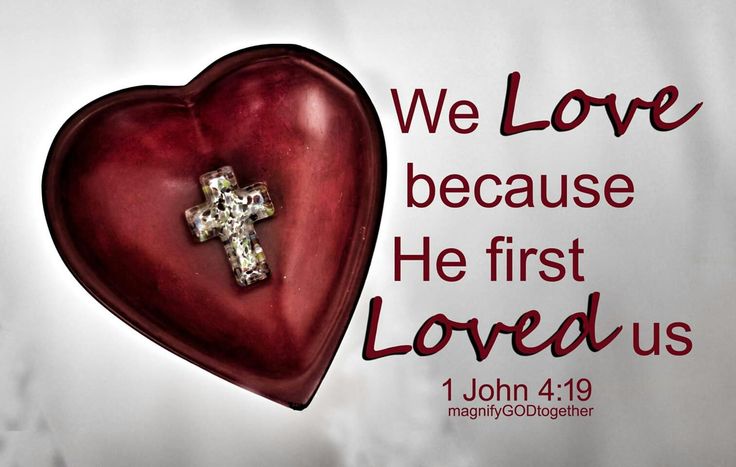 a red heart with a cross on it and the words we love because he first loved us