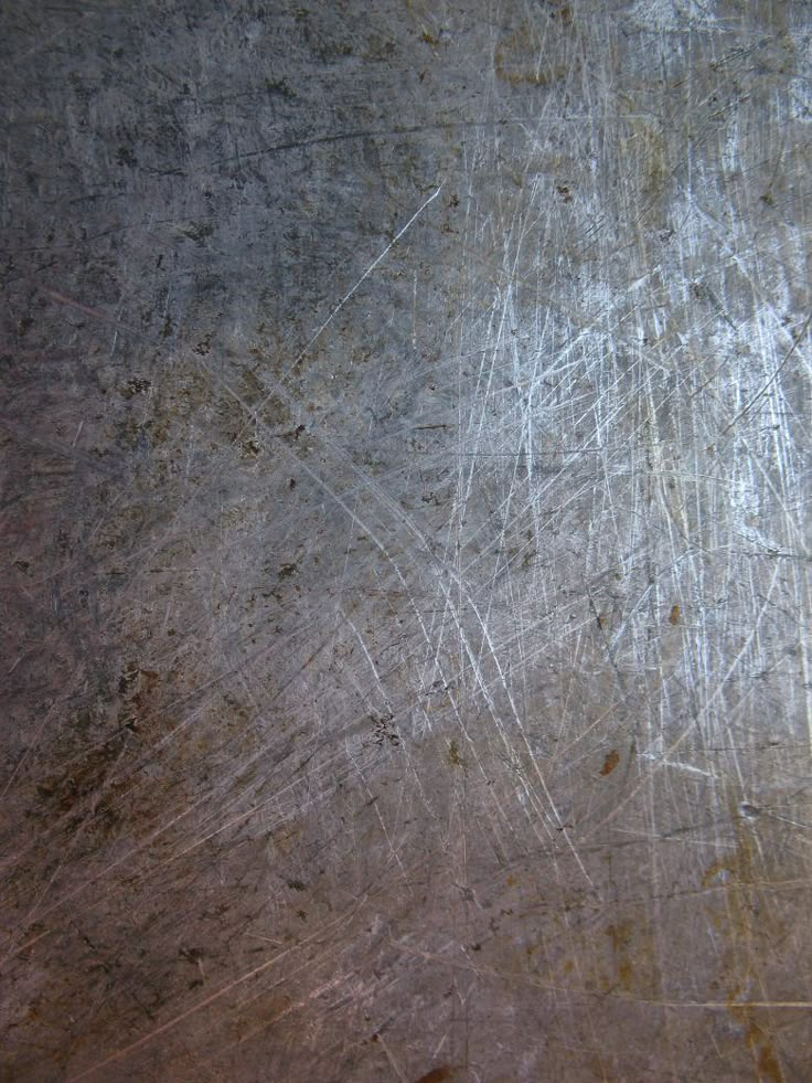 an old metal surface with scratches on it