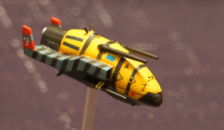 a yellow and black toy airplane on a stick