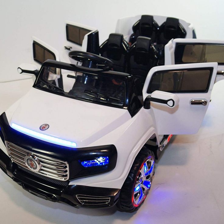 a white toy car with lots of seats and lights on it's front end