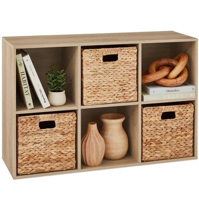 a shelf with baskets and books on it