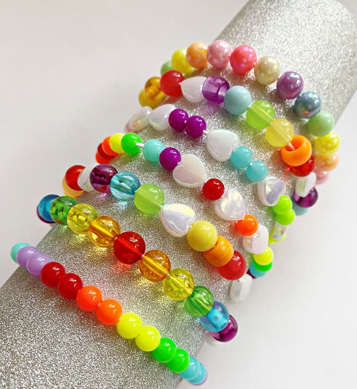 "Rainbow Friendship Bracelets Not just for PRIDE, but oh so perfect for it Fun, colorful and meaningful, these are for all ages and genders. A mix of Rainbow colored beads and hearts. Perfect for: YOU, Pride Month, Pride parties, LGBTQIA groups, giveways, favors and more! ♥wear them ♥gift them ♥collect them ♥share them DETAILS: approximately 7\" perfect for young adults, adults (this is a common size for these) - contact us if you need alternate sizes: (6\" kids / 8\" adults with large wrists) T Hypoallergenic Rainbow Bracelets With Round Beads, Hypoallergenic Rainbow Beaded Bracelets, Adjustable Rainbow Friendship Bracelets For Birthday, Rainbow Colorful Beads Friendship Bracelet Gift, Multicolor Friendship Bracelets With Colorful Beads As Gift, Rainbow Crystal Bracelet With Round Beads For Gift, Colorful Adjustable Crystal Bracelet As Gift, Colorful Adjustable Crystal Bracelet Gift, Colorful Adjustable Crystal Bracelet For Gift