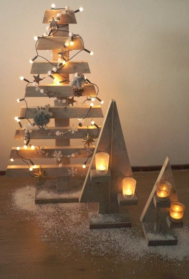 a christmas tree made out of wooden boards and lit candles