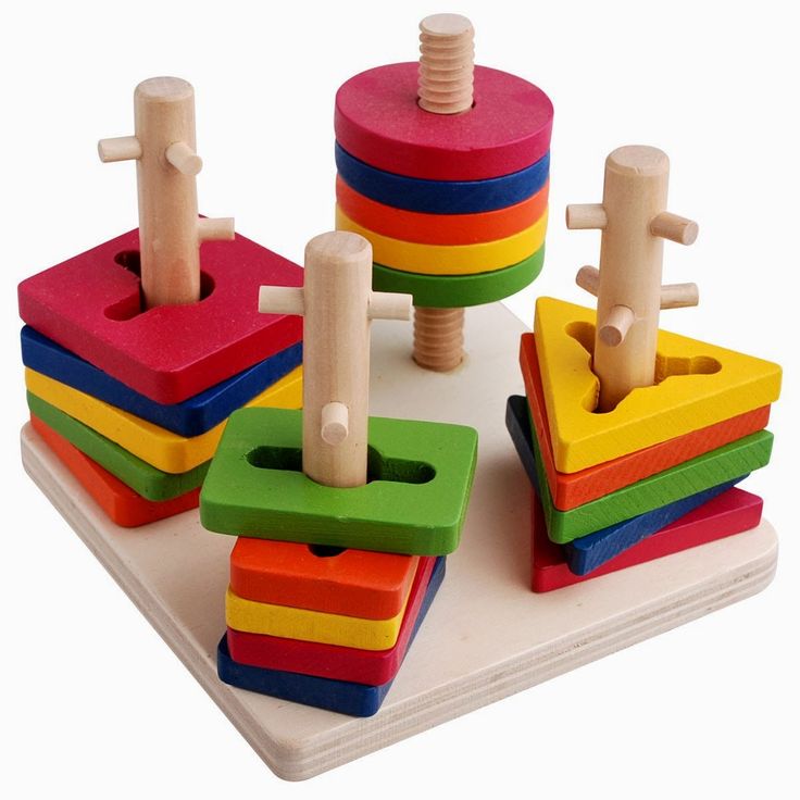 a wooden toy set with different colored blocks and pegs