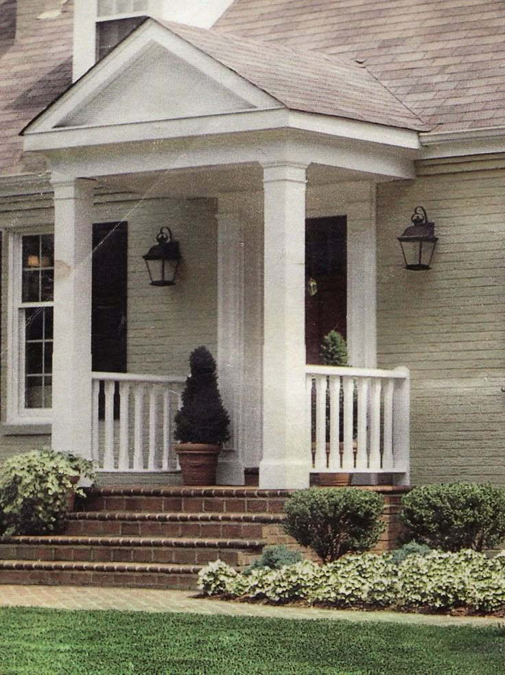 a person standing on the front porch of a house