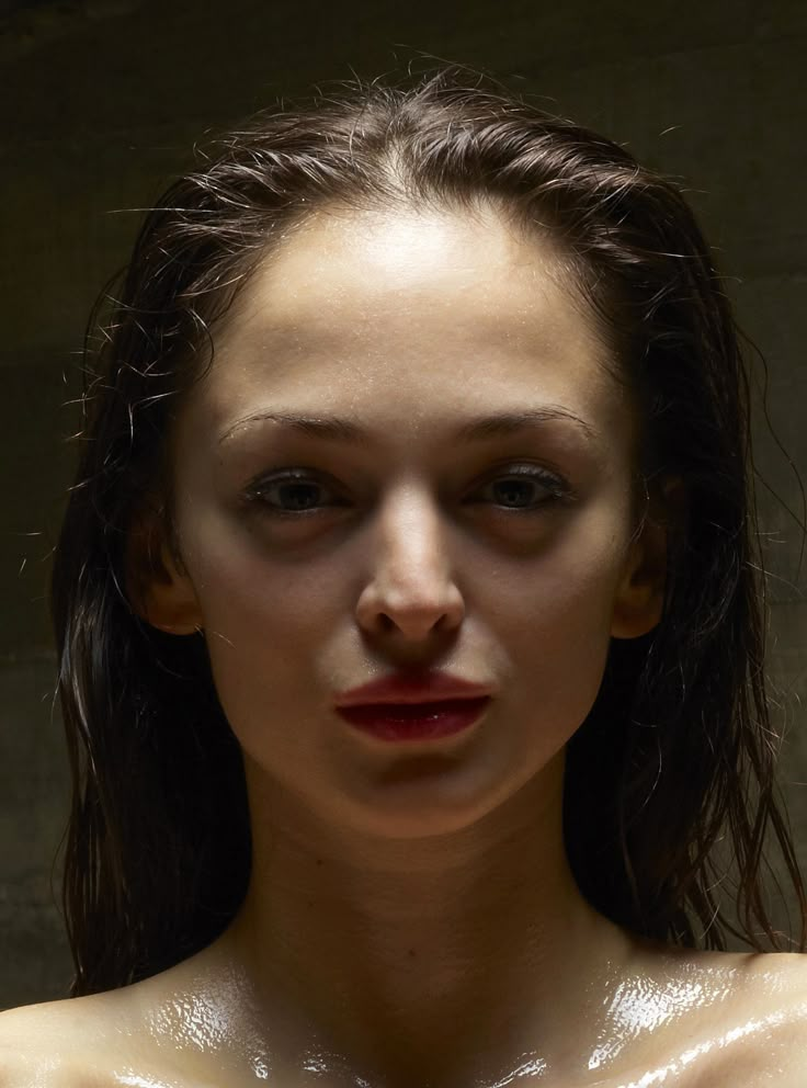 a woman with wet skin and red lips