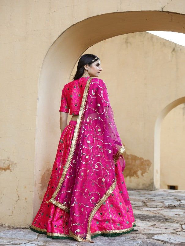 Tradition never goes out of style. Golden and floral brocade lehenga-blouse set matched perfectly with hand-crafted organza dupatta. Taari and lace embedded together in a gorgeous jaal. Color: Pink Fabric: Lehenga & Blouse- Brocade Dupatta - Organza Note: Length and sizes can be customised Length - Lehenga 44 inches Blouse 14 inches Available in other colors If you happen to see some deformity in hand-work or fabric, that’s mere the technique of the same and not a defect. The garment is quite pr Chanderi Lehenga For Reception And Transitional Season, Reception Choli With Gota Work In Chanderi, Chanderi Choli With Gota Work For Reception, Reception Choli In Chanderi With Gota Work, Transitional Organza Choli With Sheer Dupatta, Navratri Chandbali-shaped Tissue Silk Lehenga, Transitional Festive Tissue Silk Lehenga, Transitional Tissue Silk Lehenga With Traditional Drape, Chanderi Sharara For Reception And Festivals