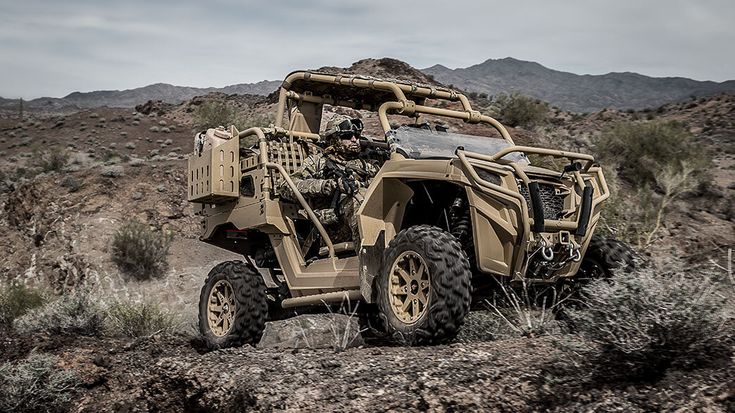 a man riding an atv in the desert