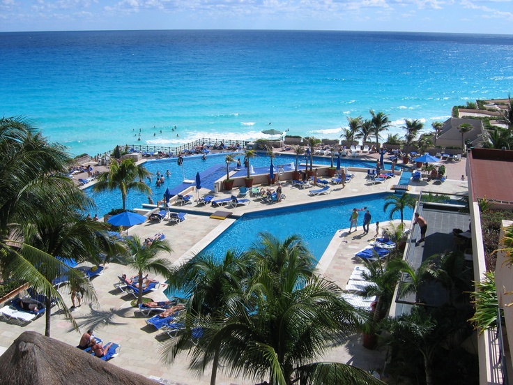 an outdoor swimming pool next to the ocean