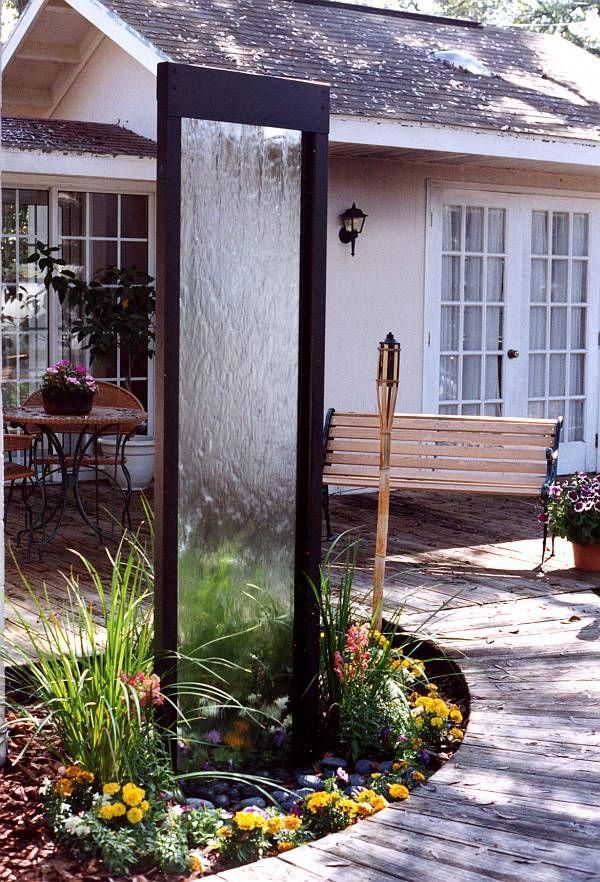 a water fountain in front of a house