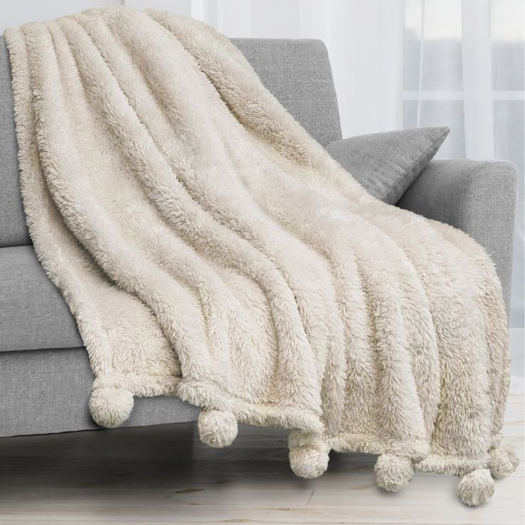 a couch with a blanket on top of it in front of a color swat list