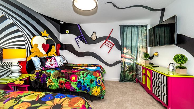 a brightly colored bedroom with black and white walls