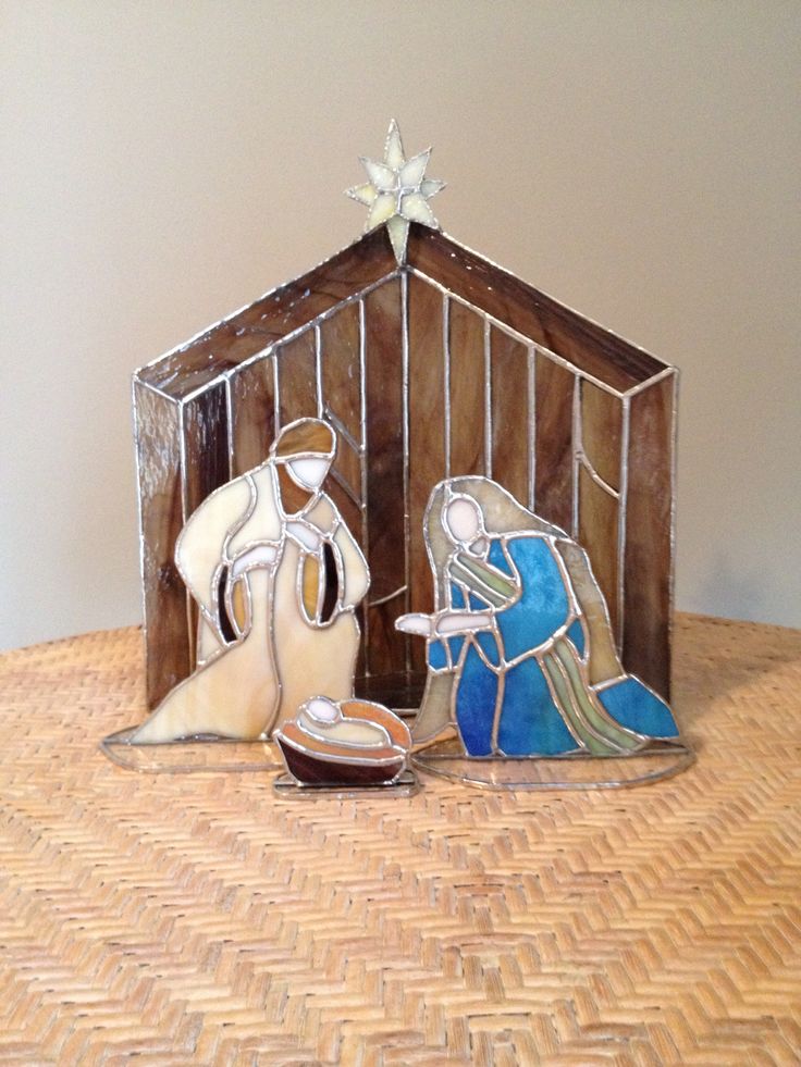 two nativity figurines sitting on top of a table