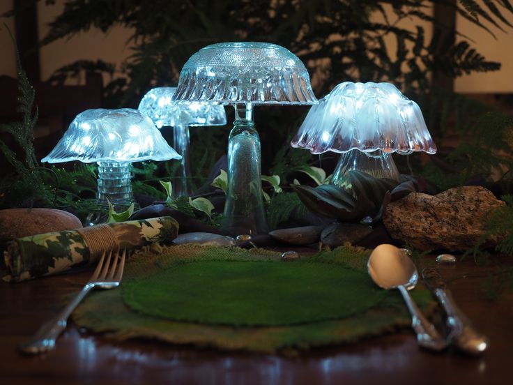 there are three lights on top of the glass mushrooms and one light is turned on