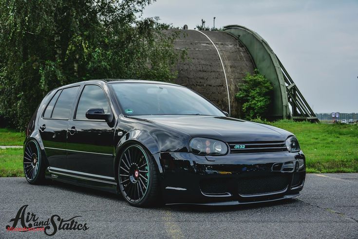 a black car parked on the side of a road