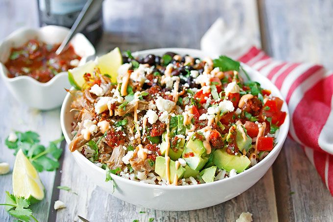 a white bowl filled with rice and vegetables