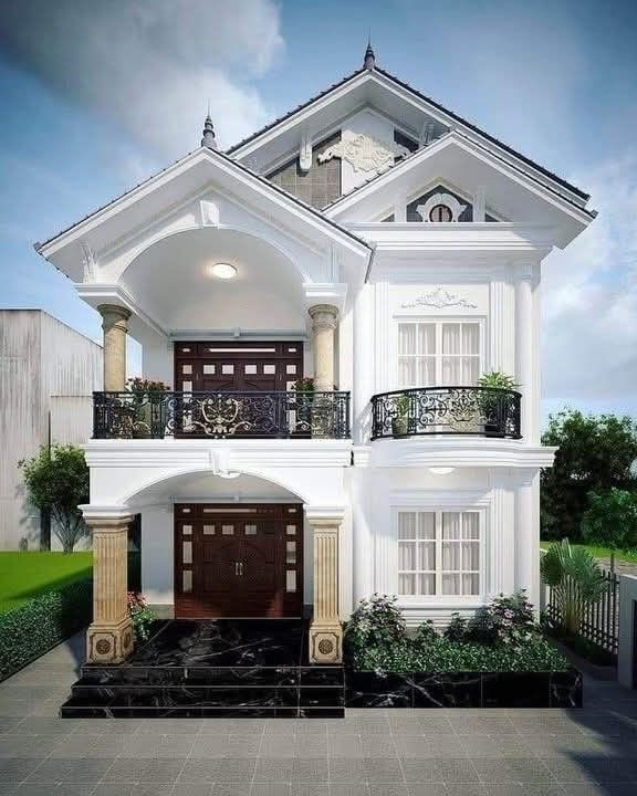 a white two story house with balcony and balconies