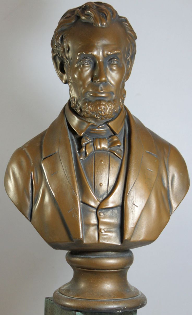 a bronze busturine of a man wearing a tuxedo