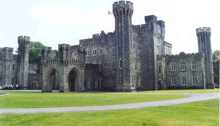 an old castle is shown with grass in the foreground