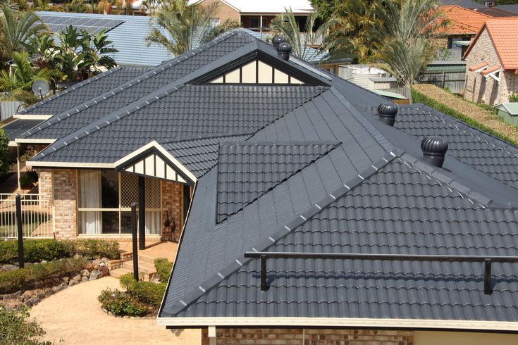 an aerial view of a house with many windows and roof tiles on the top floor