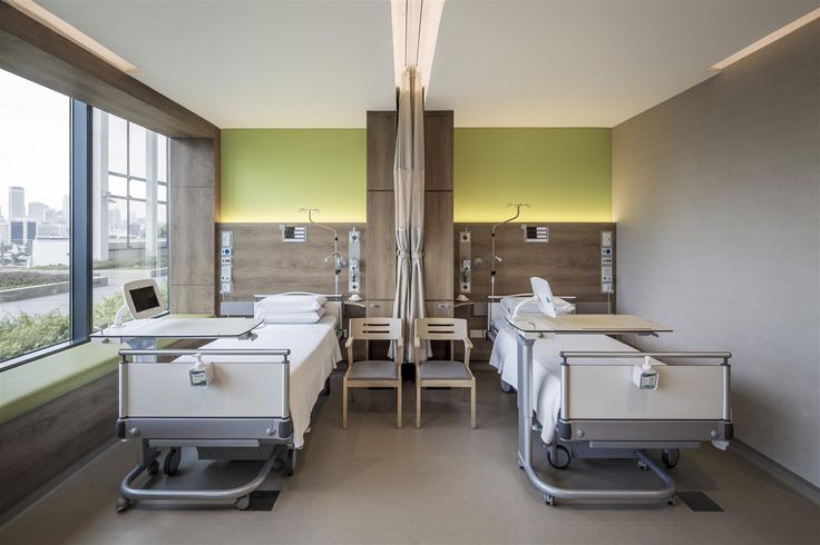 an empty hospital room with two beds in it