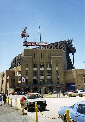 cars are parked in front of a baseball stadium