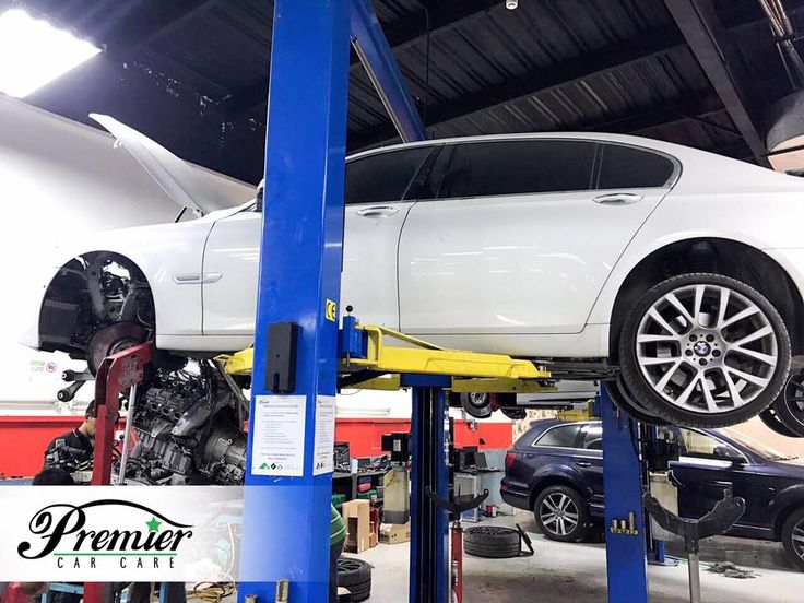 a white car being worked on in a garage