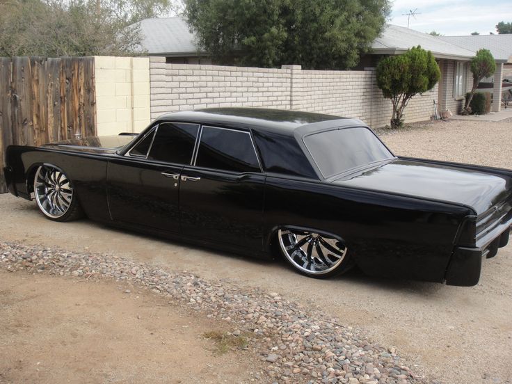 a black car parked in front of a house