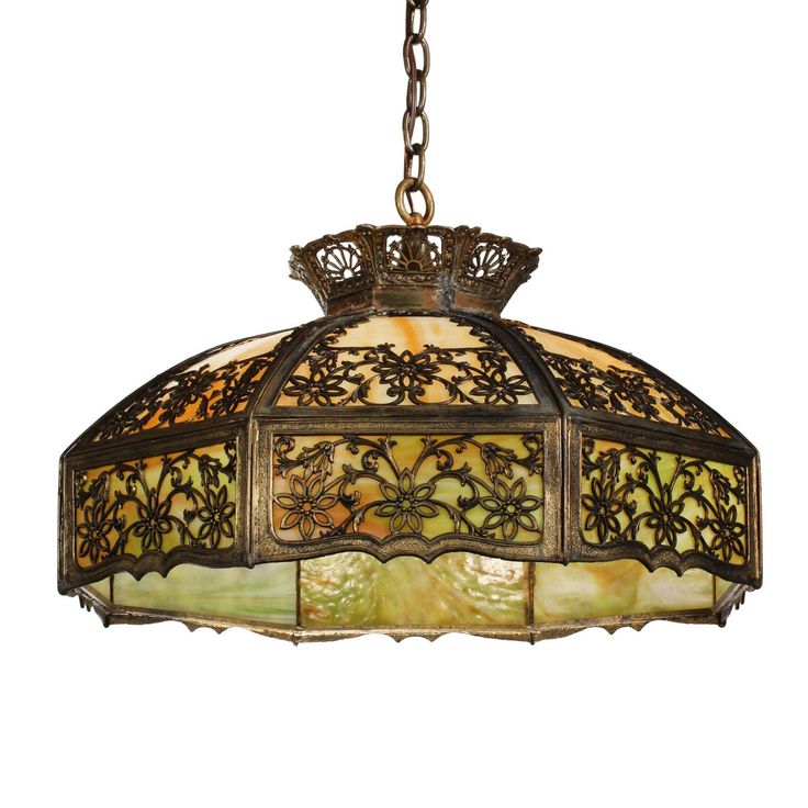 a light fixture hanging from the ceiling with an intricate design on it's side