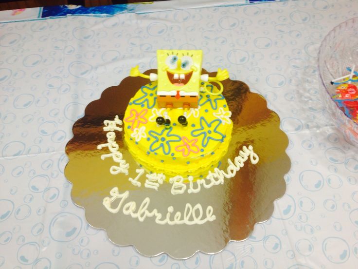 a birthday cake that is shaped like a spongebob on top of a table