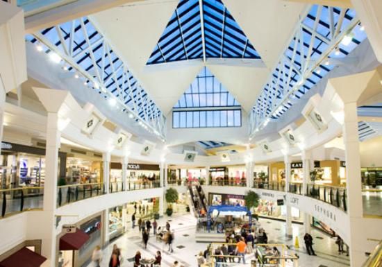 the inside of a shopping mall filled with people