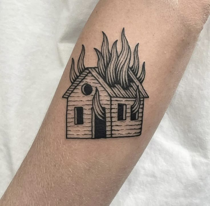 a small house with flames coming out of it on the left forearm and right arm